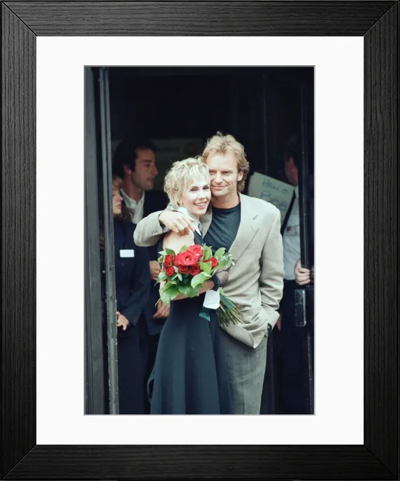 Framed Print : Sting holds and his bride Trudie Styler outside Camden register office, London