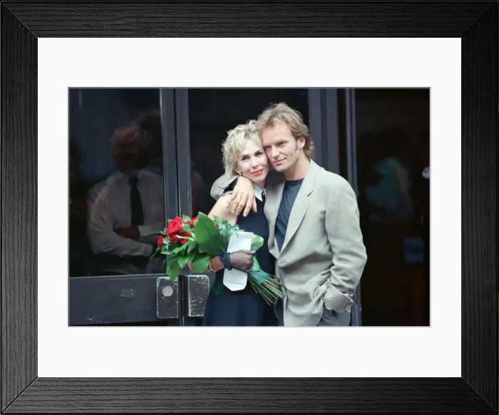 Framed Print : Sting holds and his bride Trudie Styler outside Camden register office, London