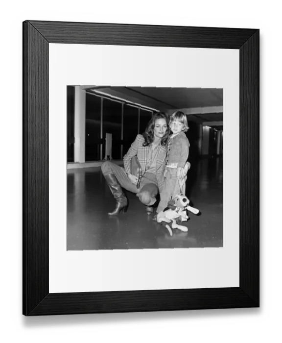 Framed Print : Charlotte Rampling at Heathrow Airport with her son Barnaby. 6th March 1976 Framed Print : Charlotte Rampling at Heathrow Airport with her son Barnaby. 6th March 1976
