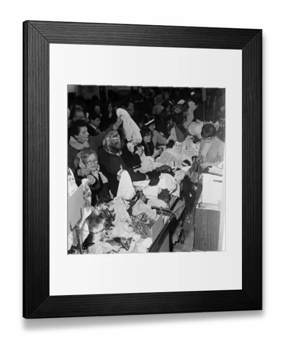 Framed Print : A group of women round one the counters at C&A on Oxford Street trying to snap up a Framed Print : A group of women round one the counters at C&A on Oxford Street trying to snap up a