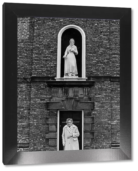 A lady stands outside Sir William Turners Almhouses, Kirkleatham. 14th February 1981