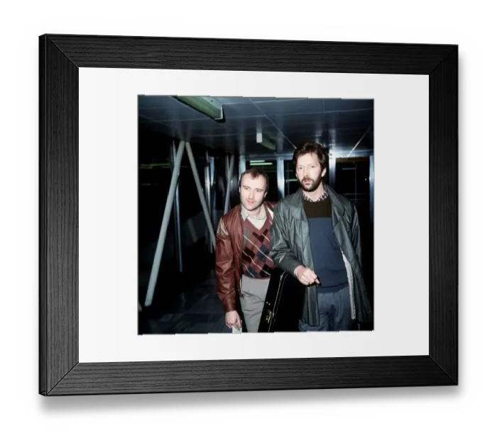 Framed Print : Phil Collins Singer Songwriter Actor with Eric Clapton leaving London Airport for Framed Print : Phil Collins Singer Songwriter Actor with Eric Clapton leaving London Airport for