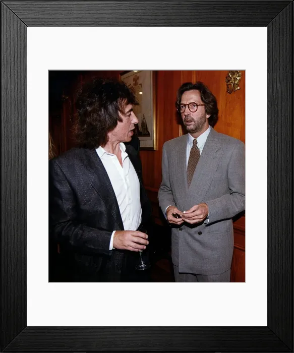 Framed Print : Eric Clapton at party chatting with Bill Wyman. 1995 Framed Print : Eric Clapton at party chatting with Bill Wyman. 1995