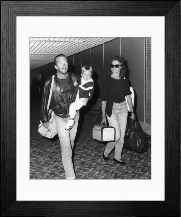 Framed Print : Eric Clapton singer songwriter and girlfriend Lori Del Santo walk through airport with Framed Print : Eric Clapton singer songwriter and girlfriend Lori Del Santo walk through airport with