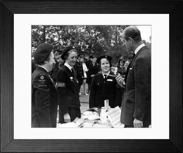 Framed Print : Prince Philip, Duke of Edinburgh, questions one of the Red Cress Cadets about the use of Framed Print : Prince Philip, Duke of Edinburgh, questions one of the Red Cress Cadets about the use of