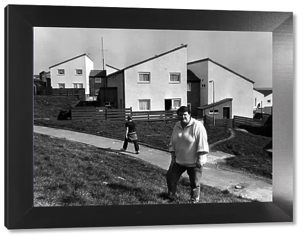 Council tenant liaison officer Denise Yeates outside refurbished houses on the Penrhys