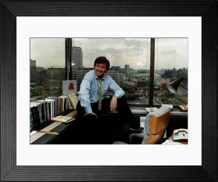 Framed Print : Melvyn Bragg sitting on office window ledge Framed Print : Melvyn Bragg sitting on office window ledge