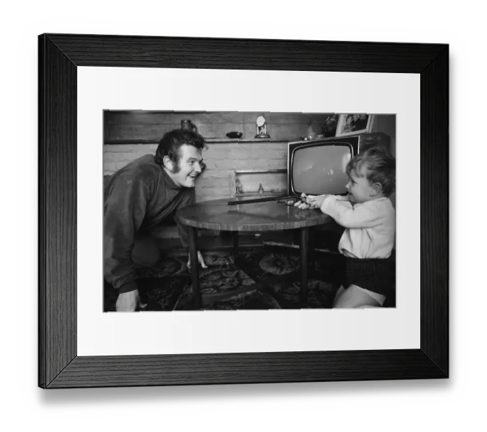 Framed Print : Liverpool goalkeeper Tommy Lawrence playing with his young son Stephen aged two Framed Print : Liverpool goalkeeper Tommy Lawrence playing with his young son Stephen aged two