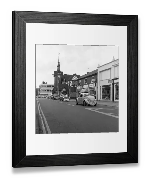 Framed Print : A parade of cars led by a decorated VW Beetle drive along Bridge Street, Stafford Framed Print : A parade of cars led by a decorated VW Beetle drive along Bridge Street, Stafford
