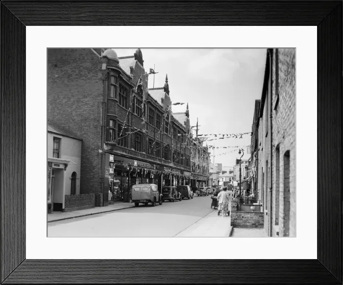 Framed Print : Flags fluttering in the breeze, decorations in traditional colours lining the streets