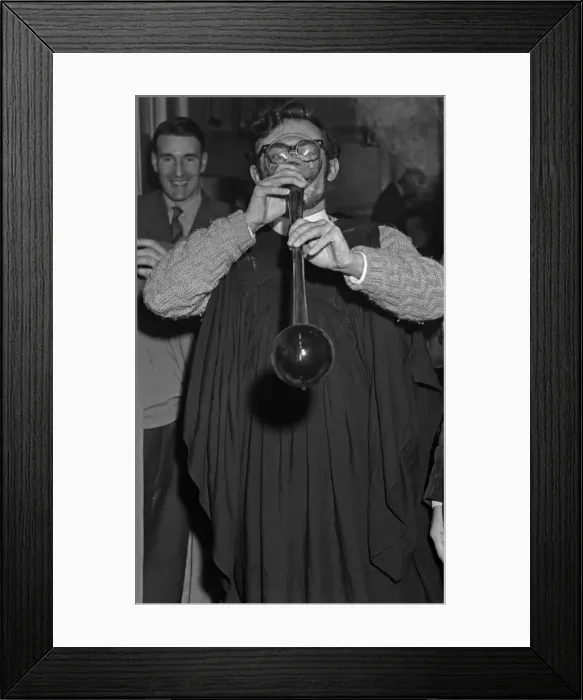 Framed Print : A student sinking a yard of ale at an unknown Cambridge pub. Circa May 1959