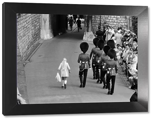 Garter Procession at Windsor Castle. A little girl joins the Guards as they march into