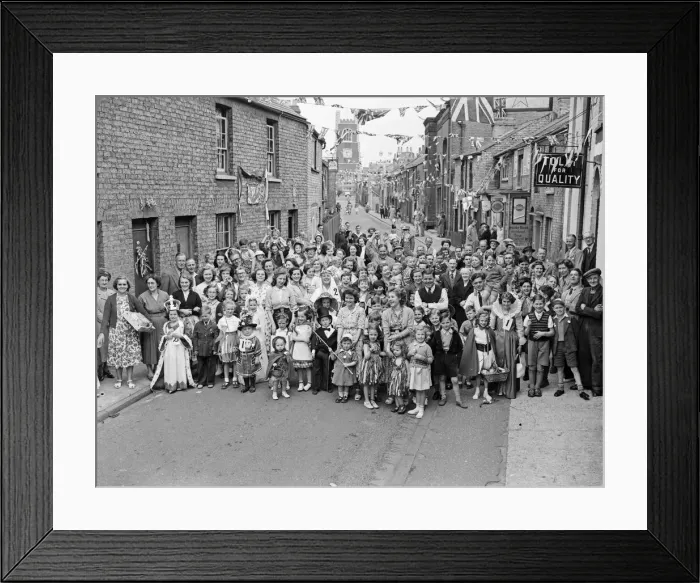 Framed Print : Flags fluttering in the breeze, decorations in traditional colours lining the streets Framed Print : Flags fluttering in the breeze, decorations in traditional colours lining the streets
