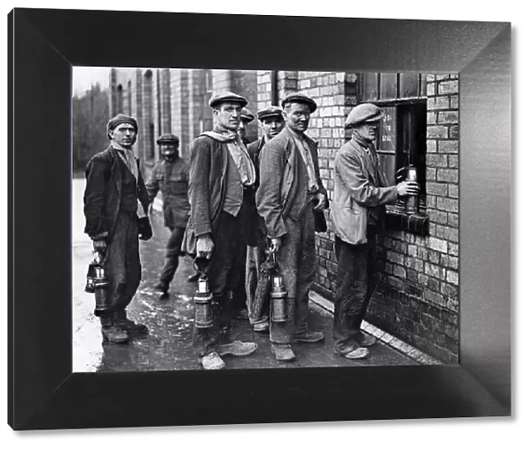 Miners at the Cannock Wood Pit handing in their Davy Lamps