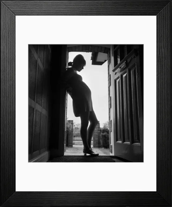 Framed Print : A pregnant woman standing in a doorway. 3rd May 1968