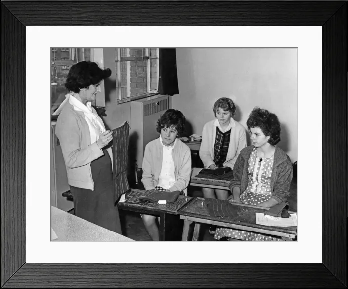 Framed Print : Mrs Lilian Burnard, trainee supervisor for hand sewing, teaching three of the girls in Framed Print : Mrs Lilian Burnard, trainee supervisor for hand sewing, teaching three of the girls in