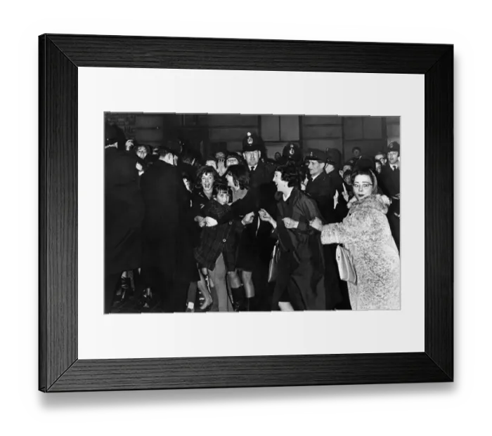 Framed Print : Teenage fans of The Beatles pop group try to break the police cordon as the band leave Framed Print : Teenage fans of The Beatles pop group try to break the police cordon as the band leave