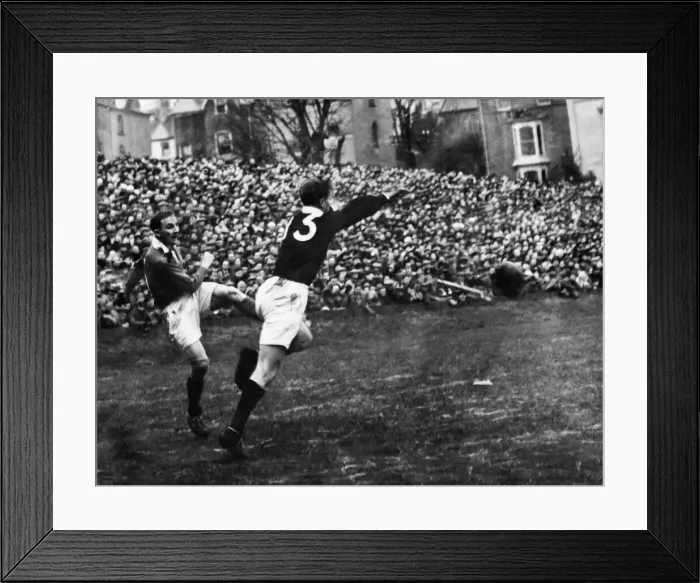 Framed Print : Lewis Jones attempting attempts to clear off the Welsh as his kick is charged down by C. W