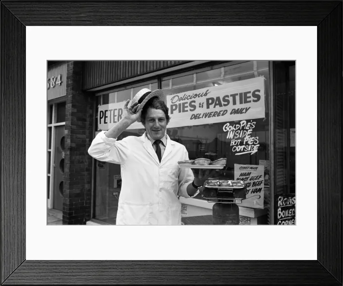 Framed Print : Customers waiting for their meat pies to warm up on the Calor gas cooker provided by Framed Print : Customers waiting for their meat pies to warm up on the Calor gas cooker provided by