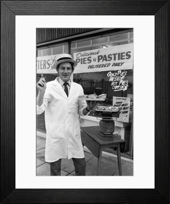 Framed Print : Customers waiting for their meat pies to warm up on the Calor gas cooker provided by Framed Print : Customers waiting for their meat pies to warm up on the Calor gas cooker provided by