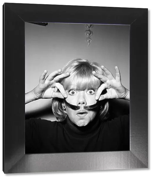 Hayley Mills wearing a genuine Dali imitation moustache, which can be bought for 12s. 6d