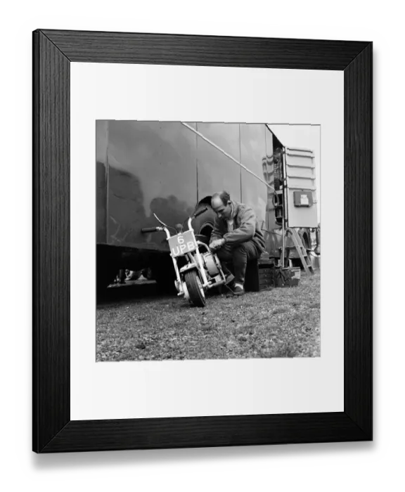 Framed Print : International 200 at Aintree motor circuit. Stirling Moss tinkers about with his scooter