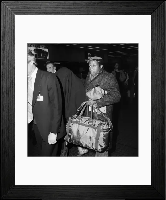 Framed Print : American pop artist Prince leaving Britain with a blanket over his head