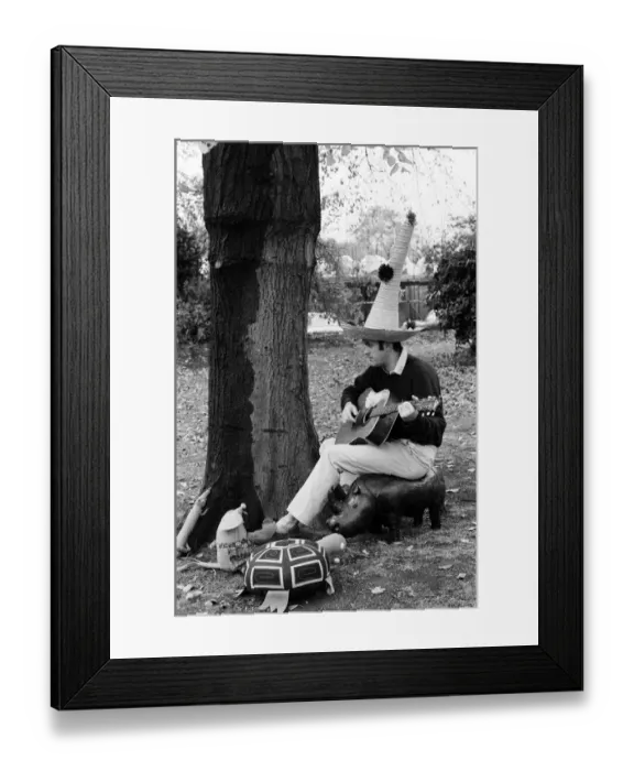 Framed Print : John Cleese relaxing in the garden of his home in Holland Park