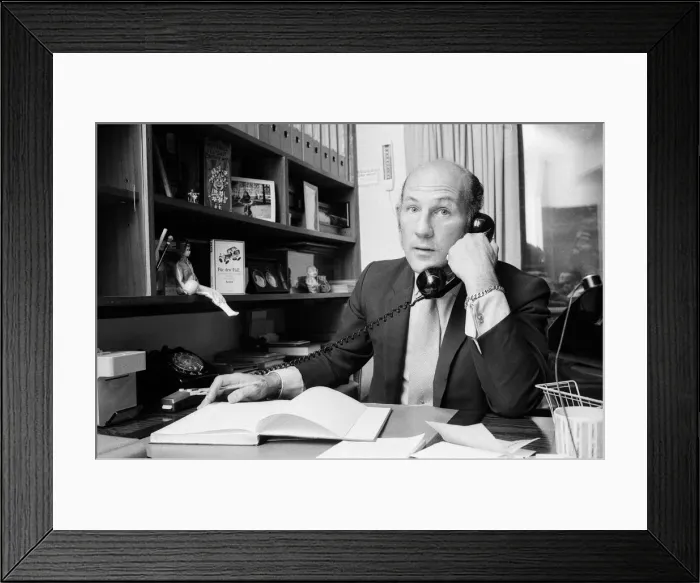 Framed Print : Stirling Moss pictured in his office / home in Shepherds Market, London. 3rd August 1973 Framed Print : Stirling Moss pictured in his office / home in Shepherds Market, London. 3rd August 1973
