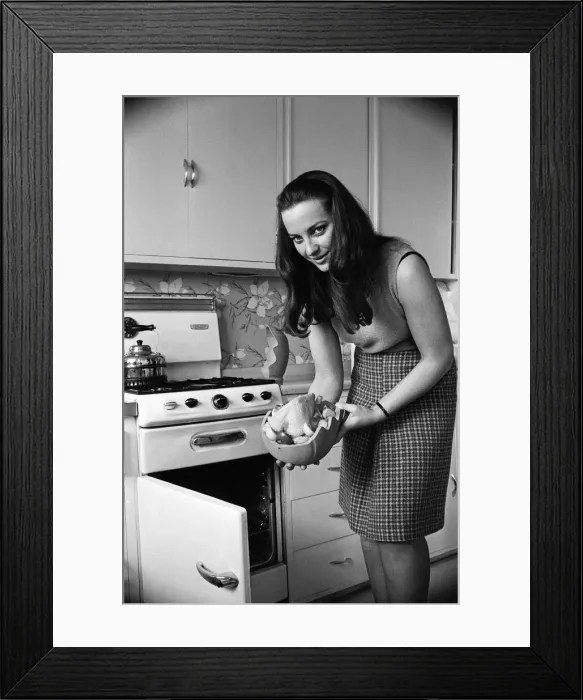 Framed Print : A woman in a kitchen cooking a chicken with a Bobo Pot. 29th March 1967 Framed Print : A woman in a kitchen cooking a chicken with a Bobo Pot. 29th March 1967