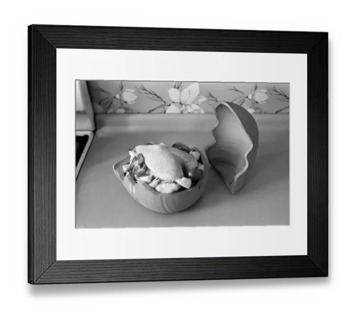Framed Print : A woman in a kitchen cooking a chicken with a Bobo Pot. 29th March 1967