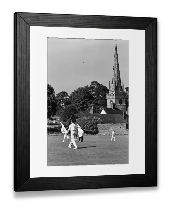 Framed Print : A cricket match takes place in the village of Wombourne in Staffordshire, England Framed Print : A cricket match takes place in the village of Wombourne in Staffordshire, England