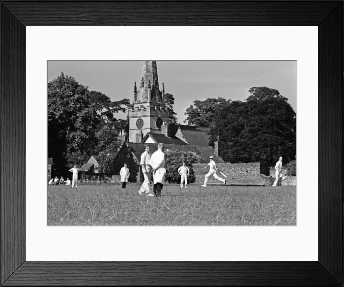 Framed Print : A cricket match takes place in the village of Wombourne in Staffordshire, England Framed Print : A cricket match takes place in the village of Wombourne in Staffordshire, England