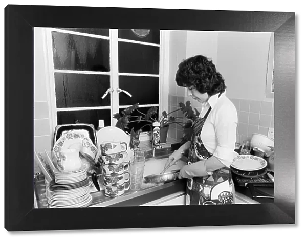 A woman washing up - one of the many daily chores of a housewife. 26th January 1979