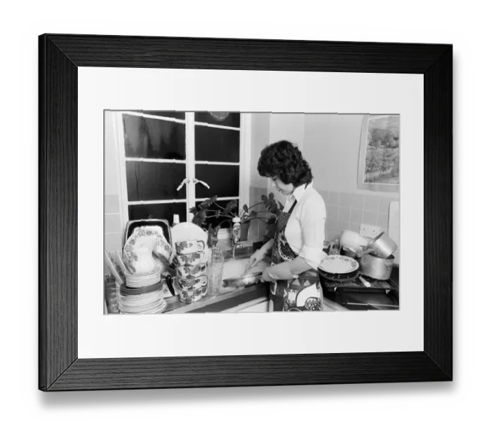 Framed Print : A woman washing up - one of the many daily chores of a housewife. 26th January 1979