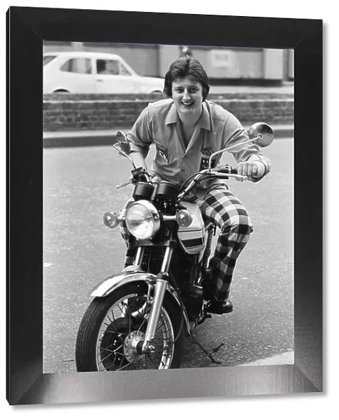 Nineteen year old dart player Eric Bristow poses in London sitting on a motorbike