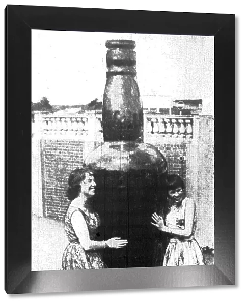 Barry Island - May 1959 - This giant bottle, 10ft high, dwarfs the two preetty girls