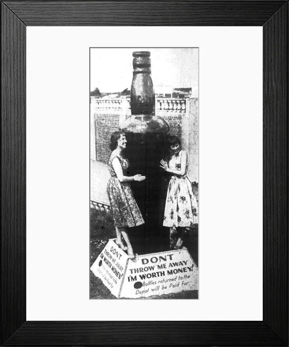 Framed Print : Barry Island - May 1959 - This giant bottle, 10ft high, dwarfs the two preetty girls Framed Print : Barry Island - May 1959 - This giant bottle, 10ft high, dwarfs the two preetty girls