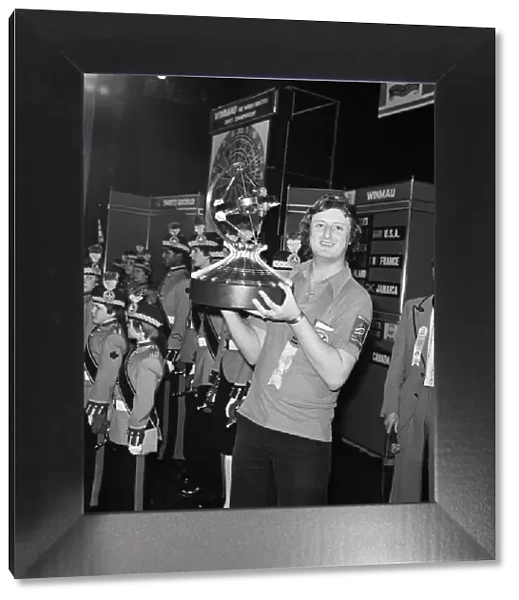 British dart player Eric Bristow holds aloft the trophy after winning the Worlds Masters