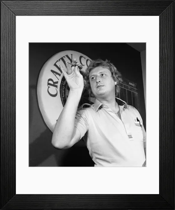 Framed Print : Close up feature on British darts player Eric Bristow in dart throwing action Framed Print : Close up feature on British darts player Eric Bristow in dart throwing action