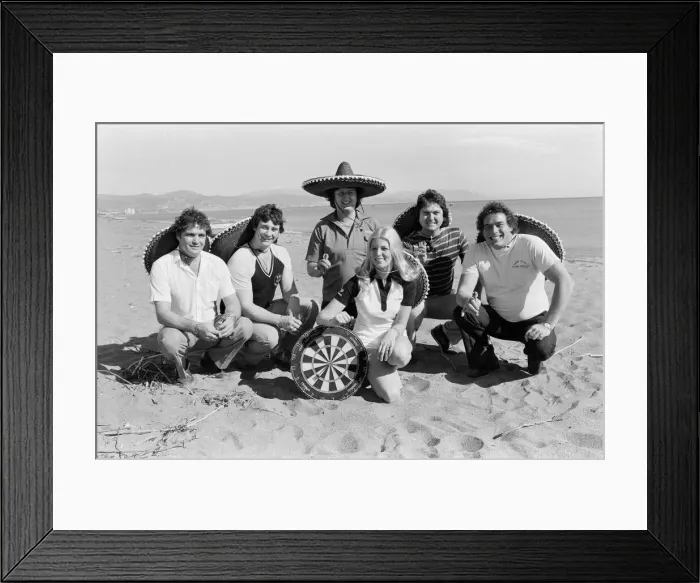 Framed Print : British darts player Eric Bristow poses on the beach with Maureen Flowers Framed Print : British darts player Eric Bristow poses on the beach with Maureen Flowers