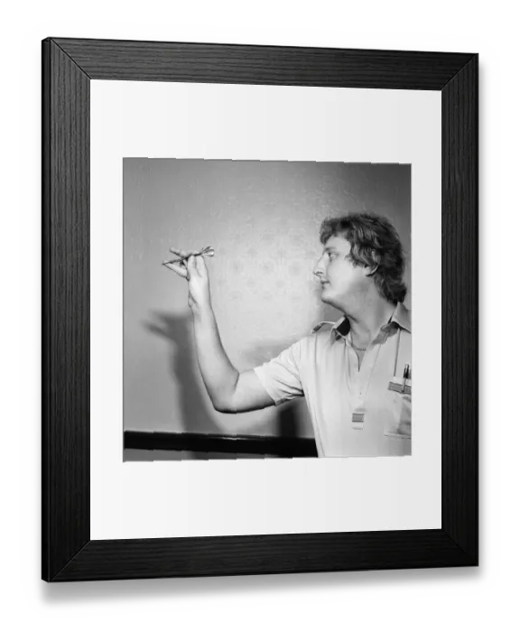 Framed Print : Close up feature on British darts player Eric Bristow in dart throwing action Framed Print : Close up feature on British darts player Eric Bristow in dart throwing action