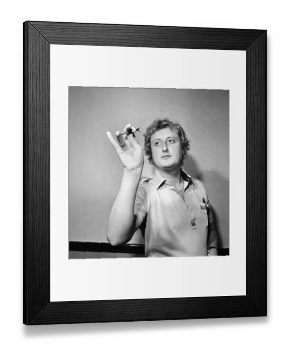Framed Print : Close up feature on British darts player Eric Bristow in dart throwing action