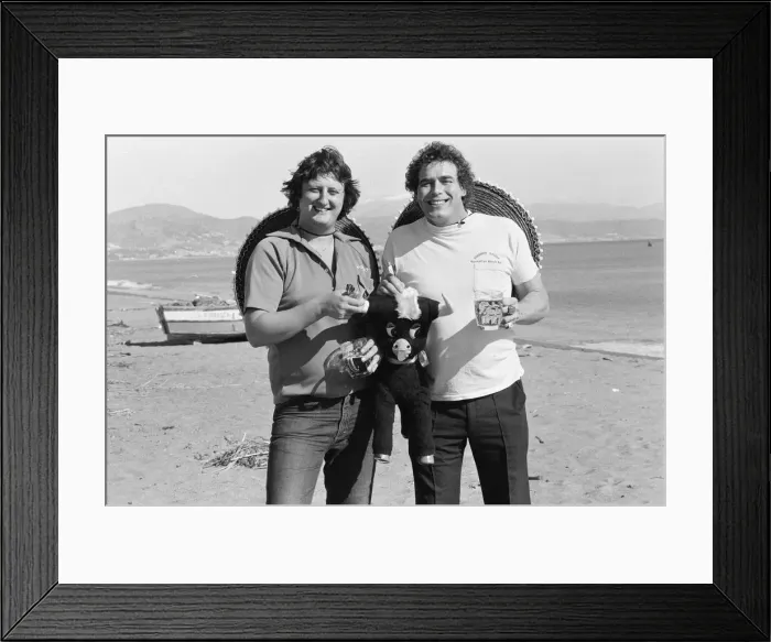 Framed Print : British darts player Eric Bristow poses on the beach with Bobby George at Torremolinos Framed Print : British darts player Eric Bristow poses on the beach with Bobby George at Torremolinos