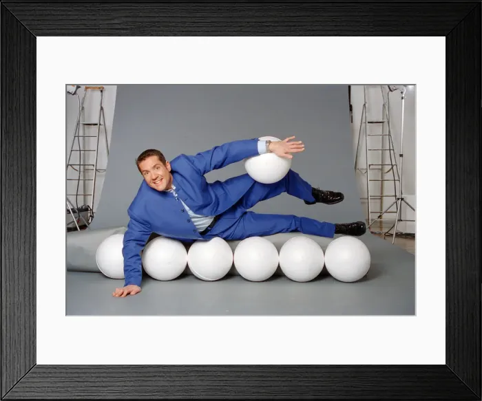 Framed Print : Dale Winton, TV presenter, poses for a studio photoshoot to celebrate his hosting of