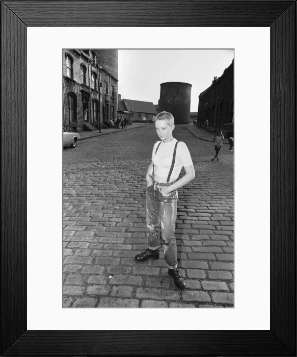 Framed Print : Seventeen year old skinhead teenager Janet Askham poses in the street at her home in Framed Print : Seventeen year old skinhead teenager Janet Askham poses in the street at her home in