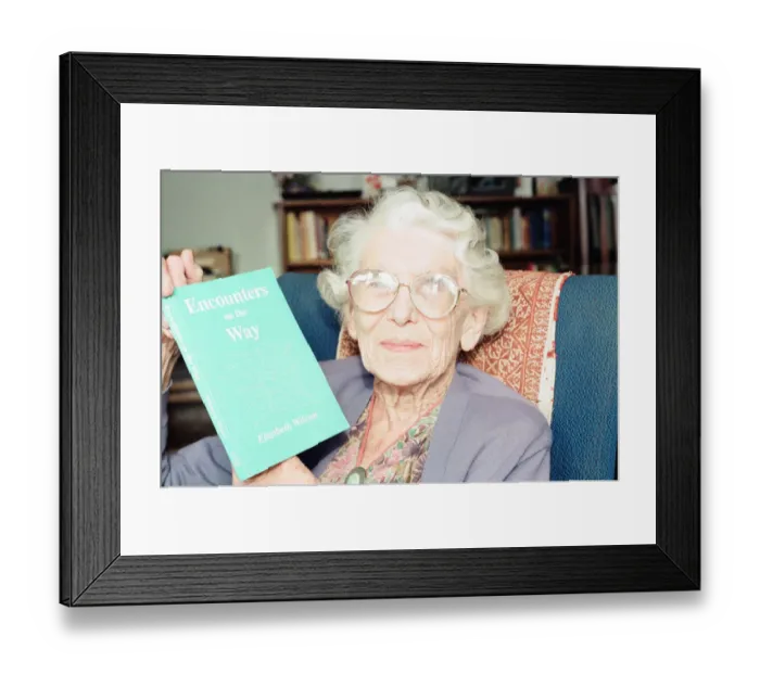 Framed Print : Elizabeth Wilson, Author with a copy of her book, Encounters on the Way, Circa 1998