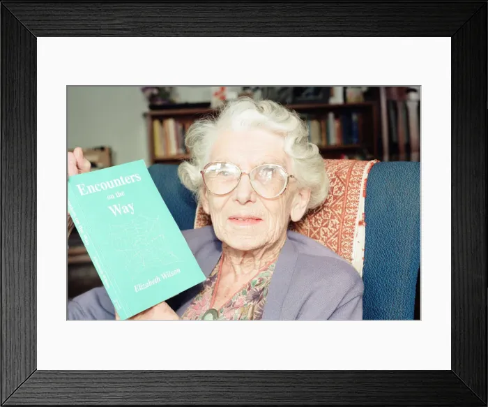 Framed Print : Elizabeth Wilson, Author with a copy of her book, Encounters on the Way, Circa 1998