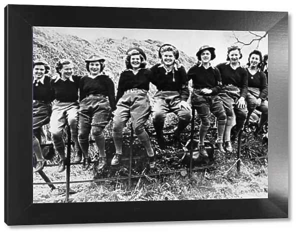 A group of happy looking Land Army girls pose for a group photograph during the Second