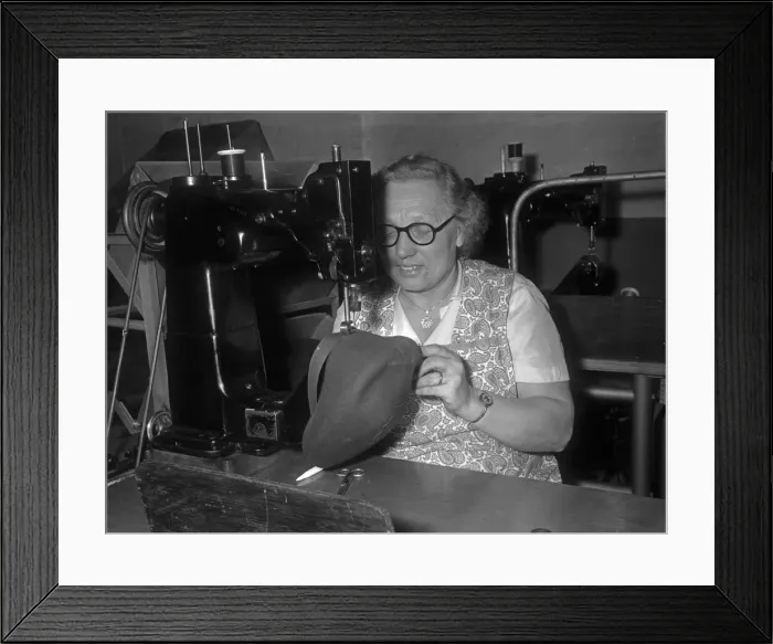 Framed Print : Seamstress sewing the inner band into a flat cap at the Denham and Hargreaves factory Framed Print : Seamstress sewing the inner band into a flat cap at the Denham and Hargreaves factory